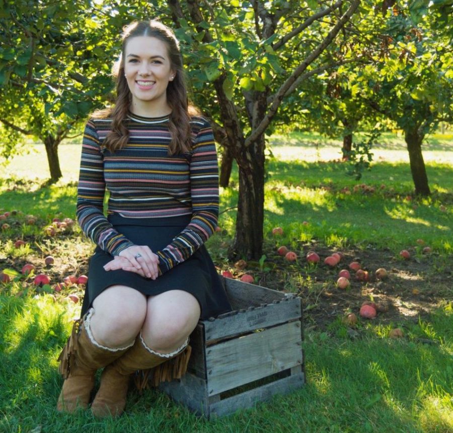 Josie+Borchert+poses+at+an+apple+orchard+for+her+senior+pictures.